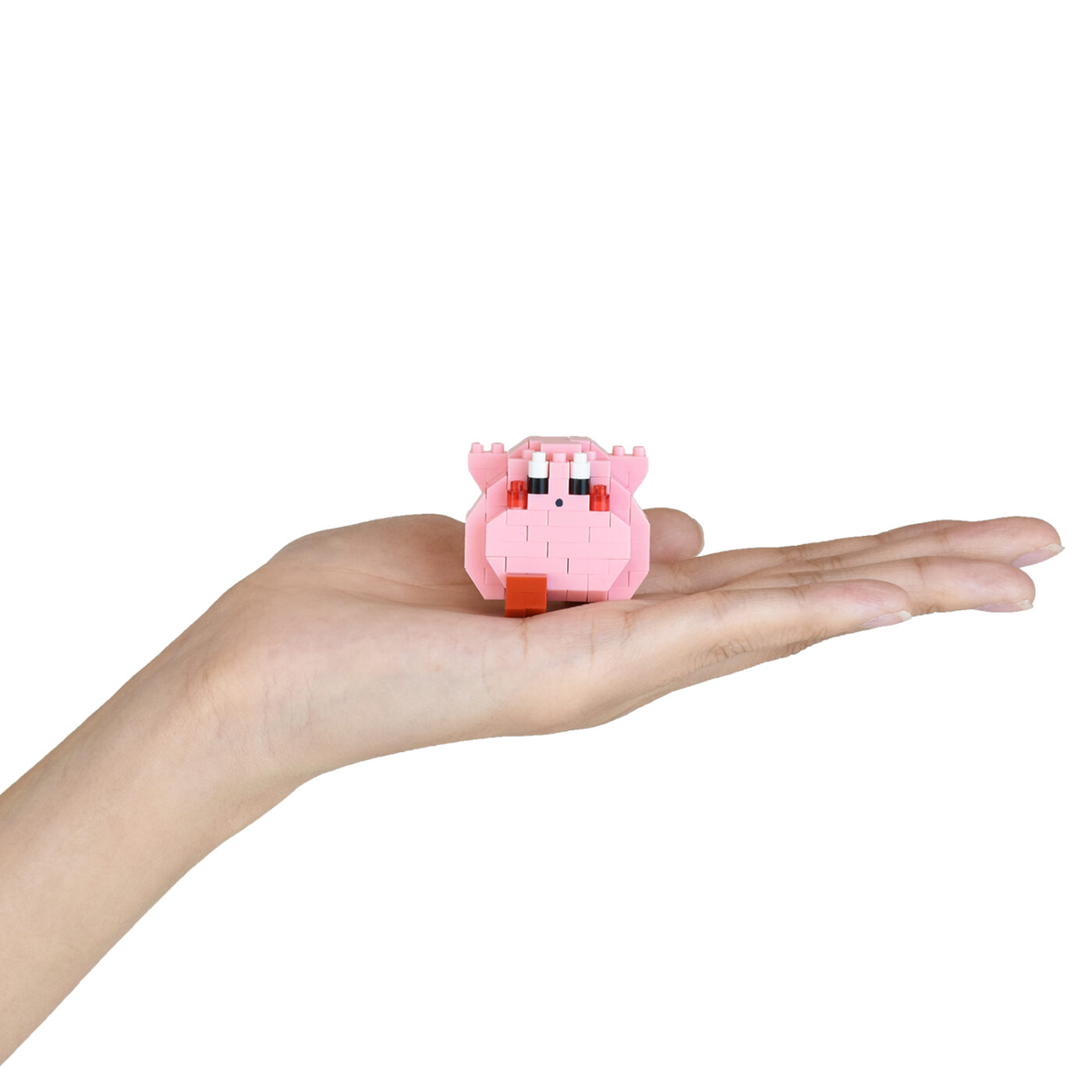 A single small mininano Kirby figure resting on an open palm