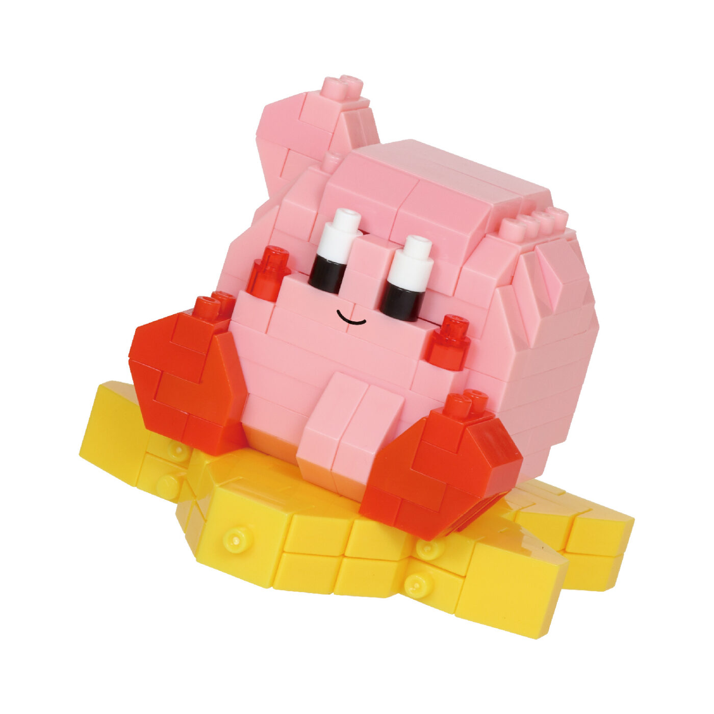 Assembled Kirby 30th anniversary nanoblock model seated on a yellow Warp Star