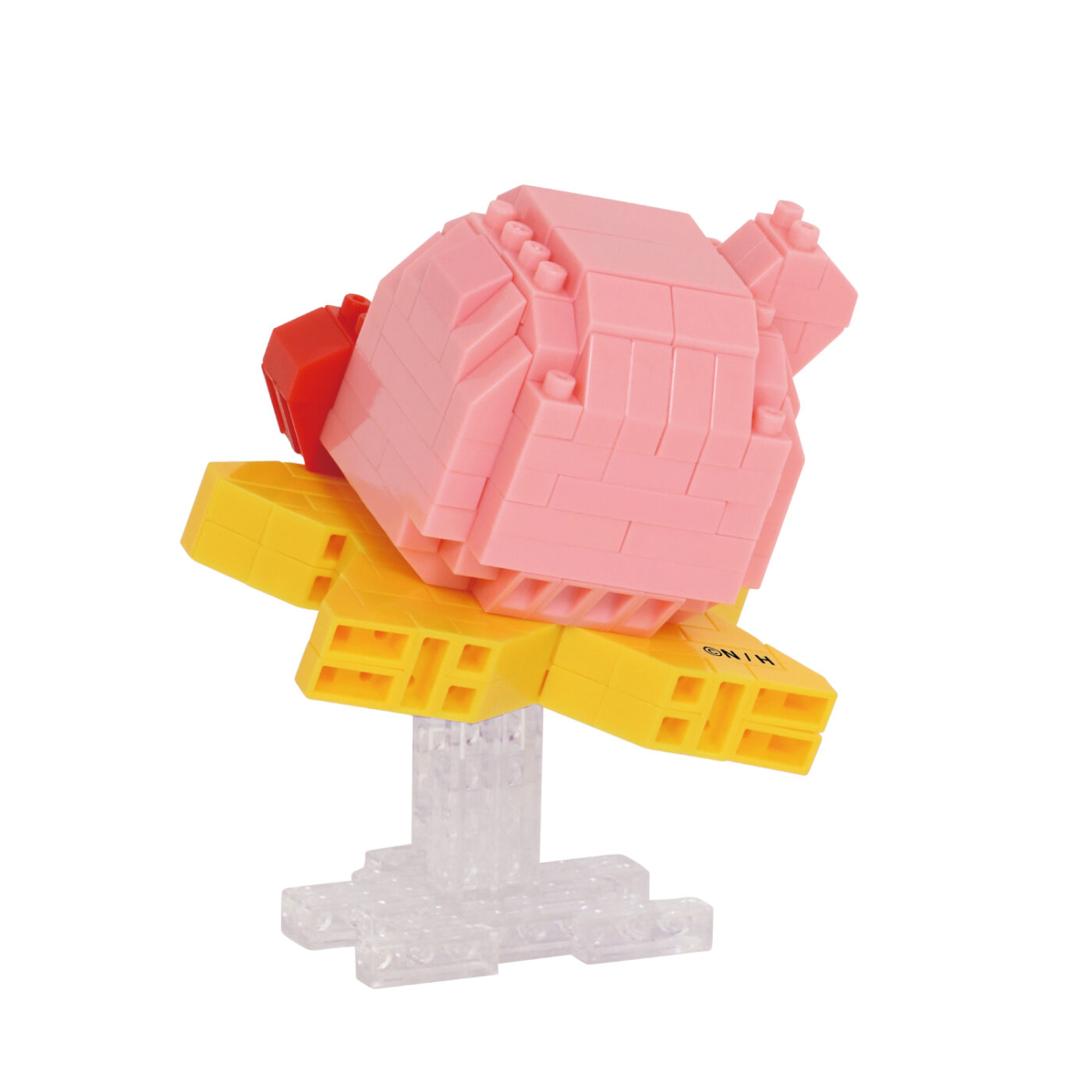 Kirby nanoblock model on a Warp Star raised on a clear support stand