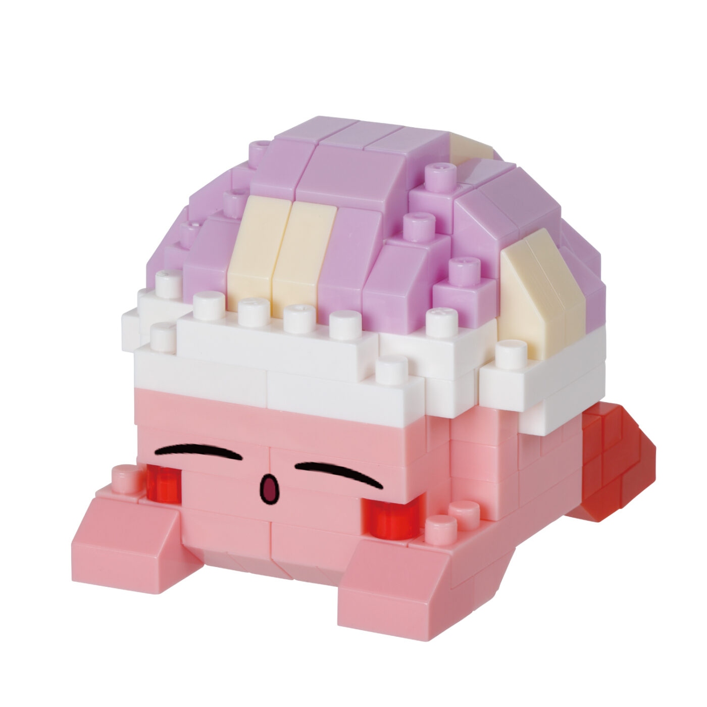 Assembled Kirby Sleep nanoblock model lying face down with eyes closed and a striped sleeping cap